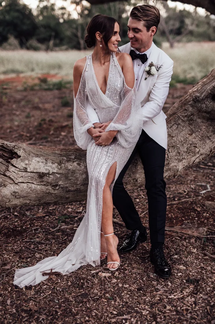 Bride and groom leaning together for a portrait in an open field